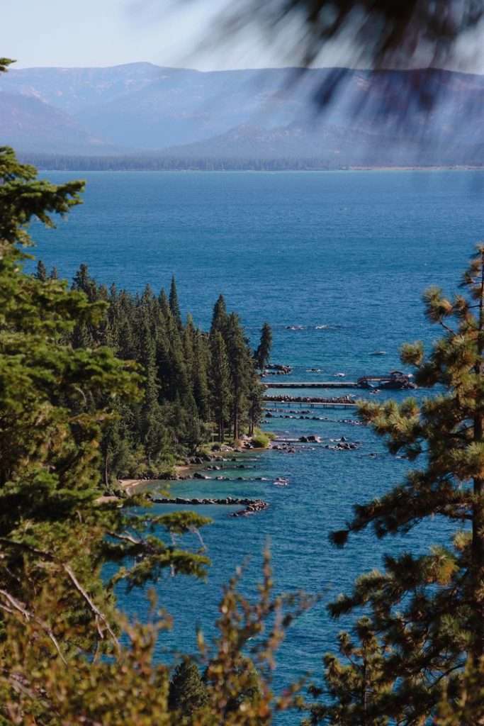 Breathtaking view of Lake Tahoe with lush coniferous forests and clear blue waters.